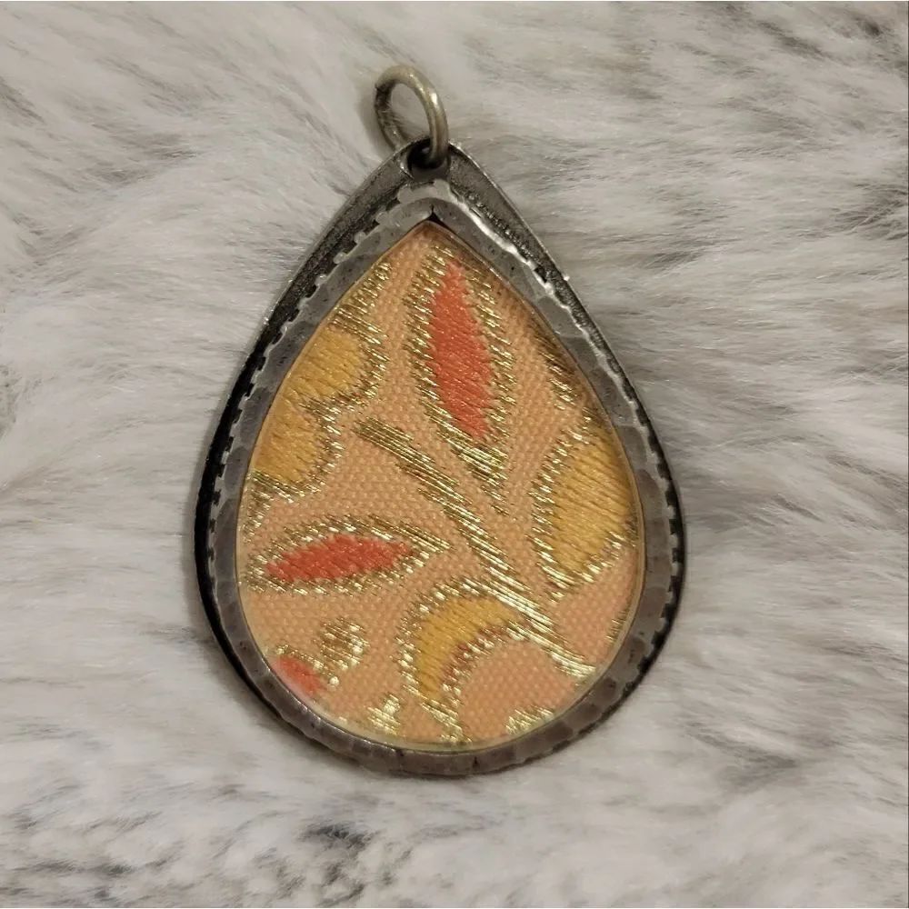 Silver pendant with fabric insert